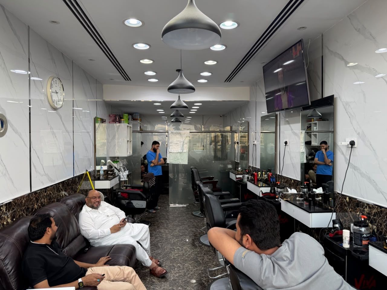 Wide view of the Friends Gents Saloon interior and barber stations